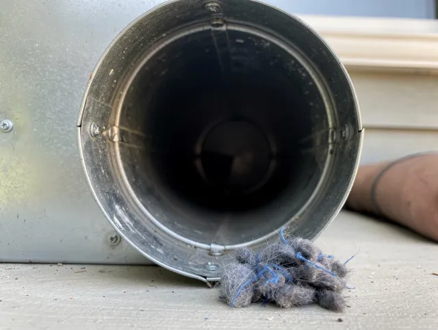 Portsmouth Dryer Vent Cleaning technician using specialized equipment to clear severe dryer vent blockage in Portsmouth